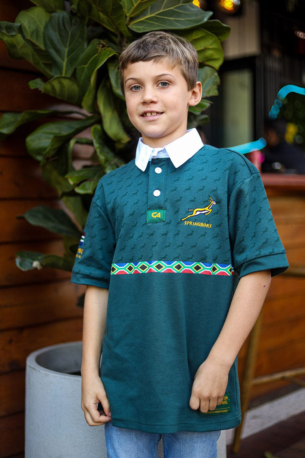 Green polo shirt with south african flag design and short sleeves.