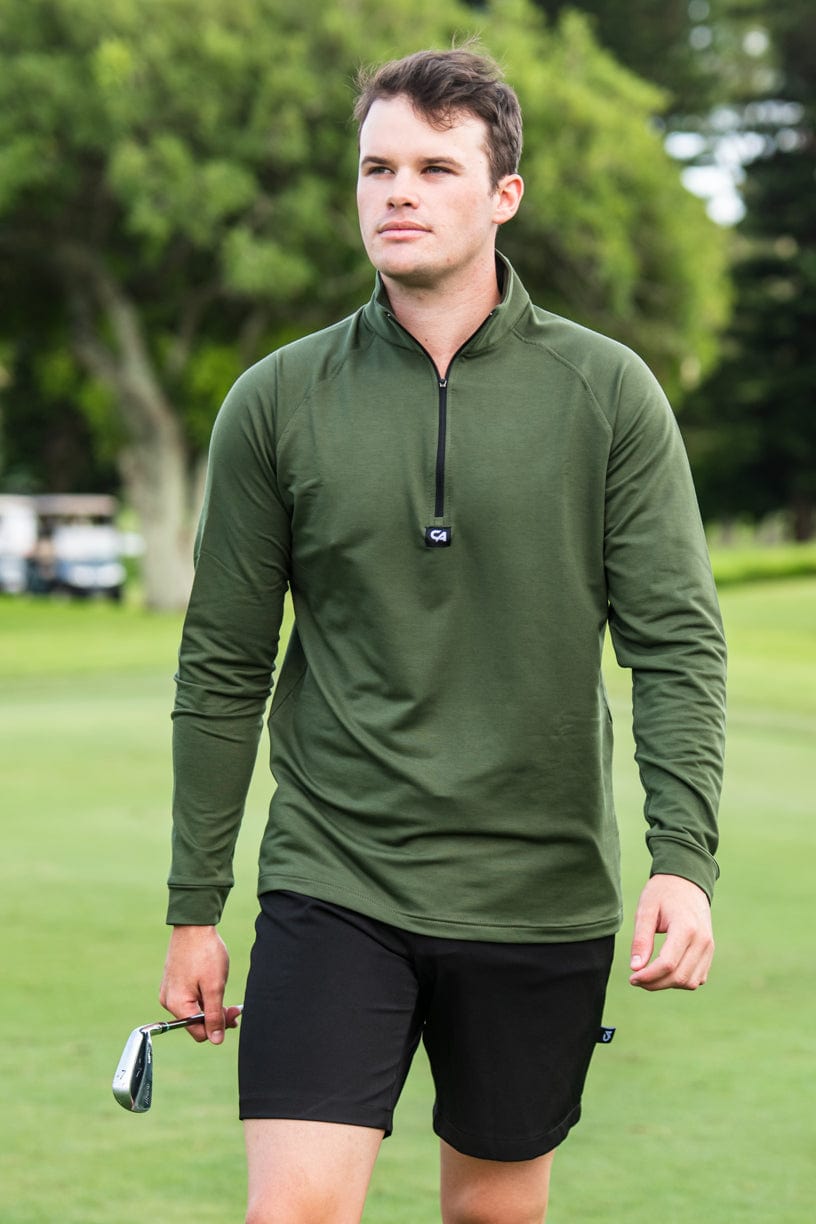 Olive green quarter-zip golf pullover with black shorts and a golf club.